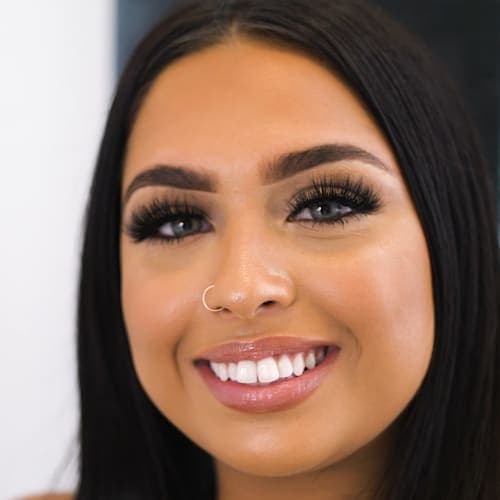 A client with a bright, beautiful smile after teeth whitening.