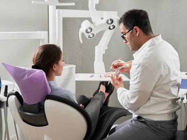 A dentist explaining his work to a patient