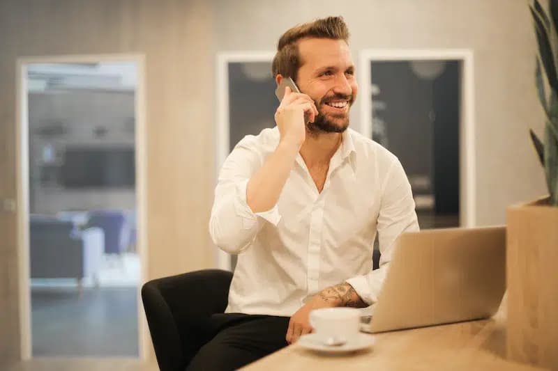 Man Talking on the phone sat at a desk