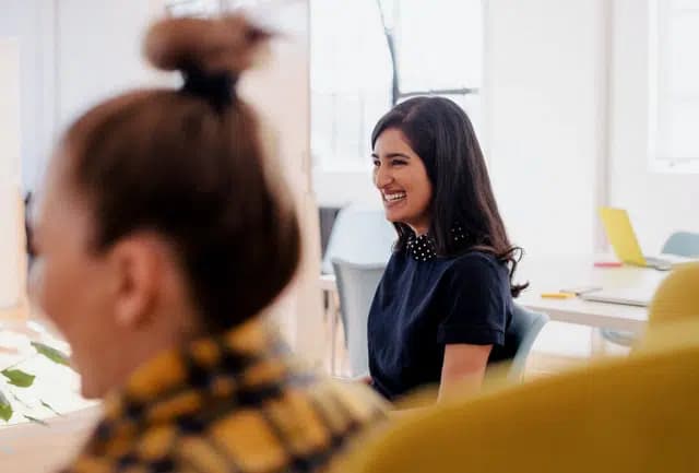 Professional woman in a meeting and smiling