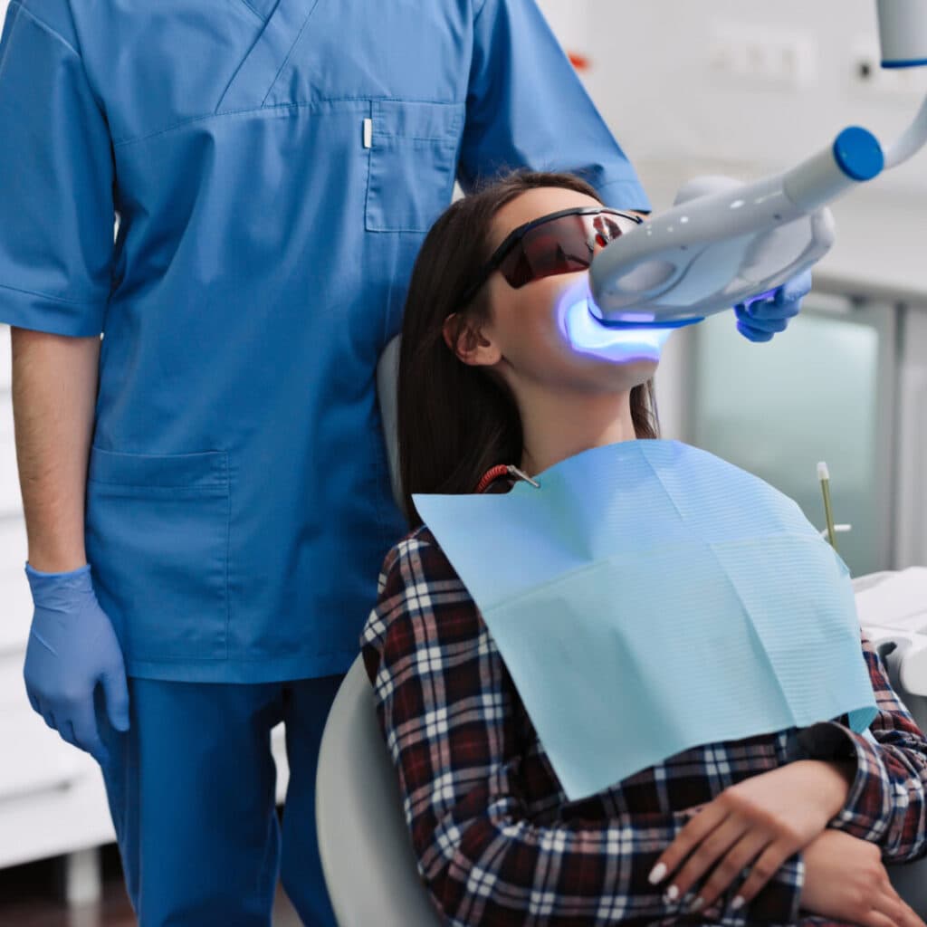 Patient undergoing dental treatment with laser.
